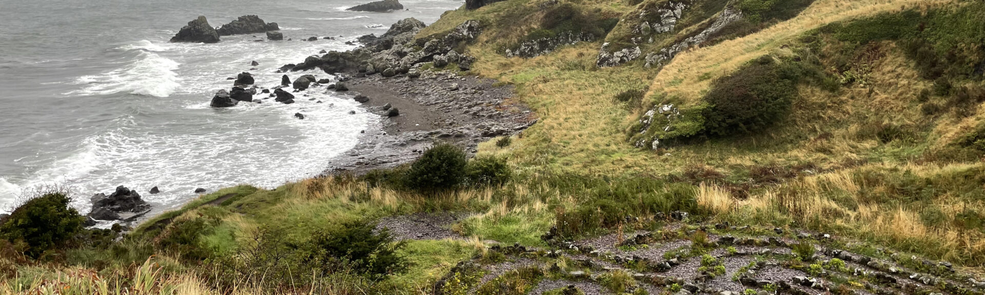 Dunure Labyrinth with castle ruins in the background. Ayrshire, Scotland - by Gina Snooks