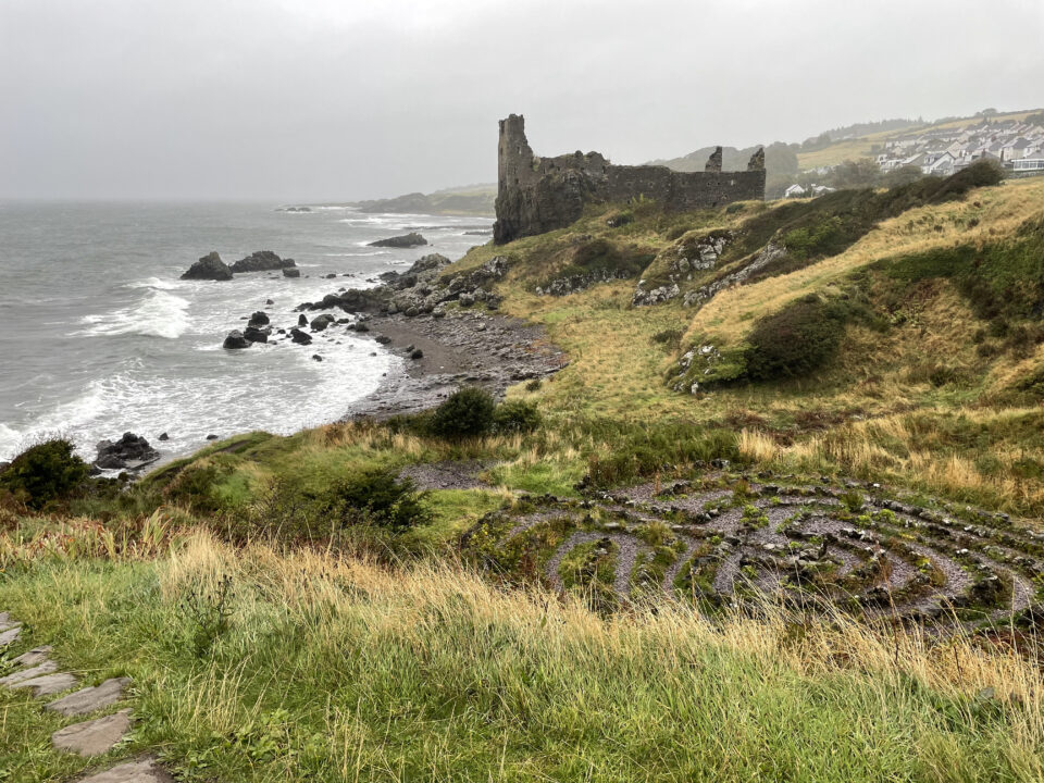 Dunure Labyrinth with castle ruins in the background. Ayrshire, Scotland - by Gina Snooks